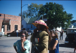 Women standing in downtown Fort Scott, Kansas. One is holding a copy of The Learning Tree.